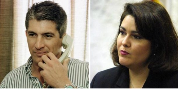 Exesposa de espía cubano reclama $7,1 millones a banco estadounidense A man in a striped shirt holds a phone, while a woman in a blazer listens attentively in a serious setting.